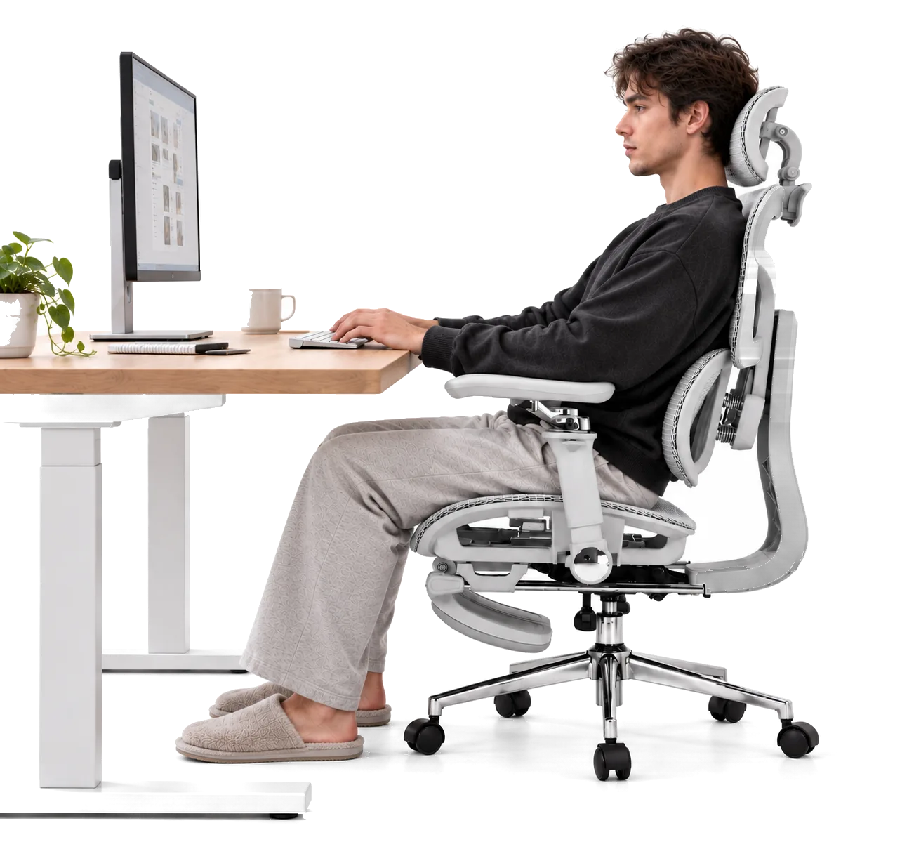 Seated upright in Aero at a desk, typing at a keyboard