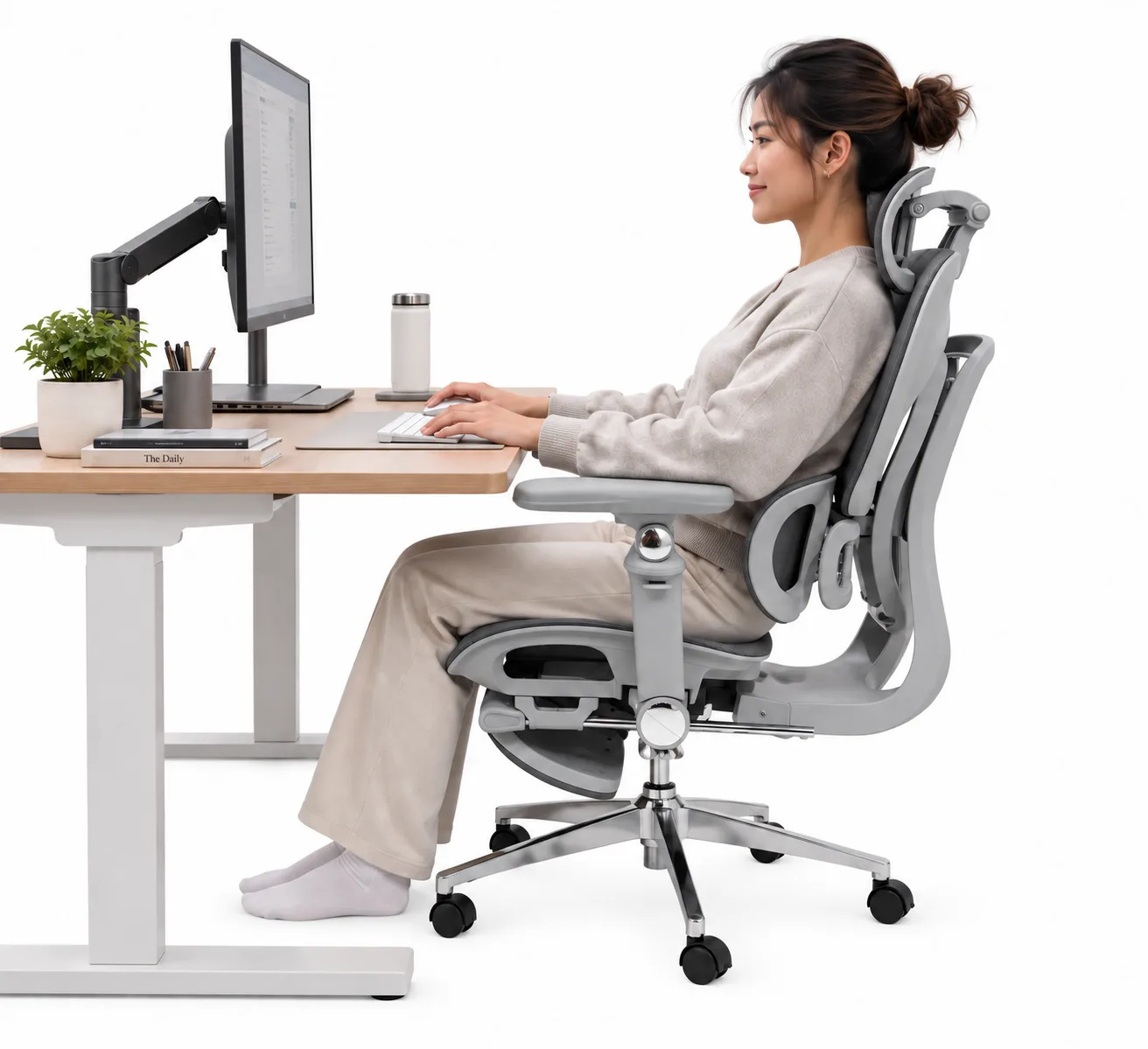 Seated upright in Atlas at a desk, typing at a keyboard